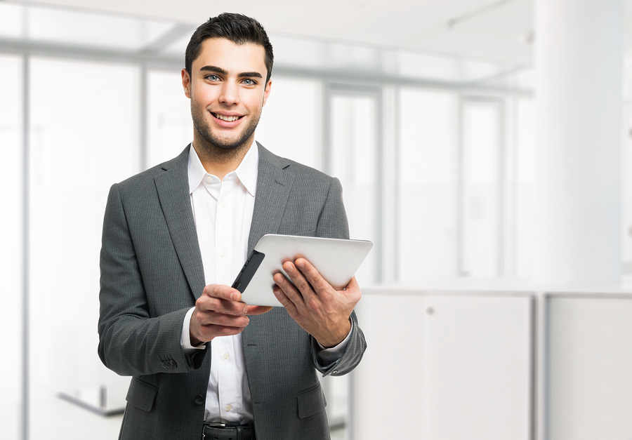 Portrait of a young business man holding his tablet